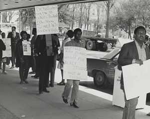 Participants in a civil rights demonstration on a sidewalk in downtown Birmingham, Alabama.