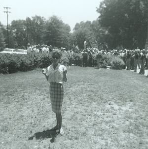 Woman on the lawn outside Foster Auditorium at the University of Alabama in Tuscaloosa.