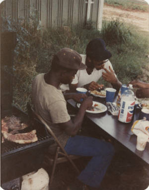 Members of the American Agriculture Movement eating barbecue at a gathering on Oscar Belvin’s farm in Montezuma, Georgia.