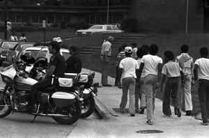African American students on the sidewalk outside of Banks High School in Birmingham, Alabama, during the integration of the school.