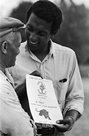 Stokely Carmichael of SNCC talking with a man during a voter registration drive in Lowndes County, Alabama.