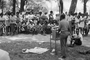 Man speaking during a rally sponsored by the Birmingham Mobilization Committee Against War and Racism at Kelly Ingram Park in Birmingham, Alabama.