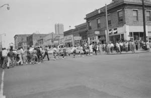 Civil rights demonstrators marching across an intersection during a protest in downtown Birmingham, Alabama.