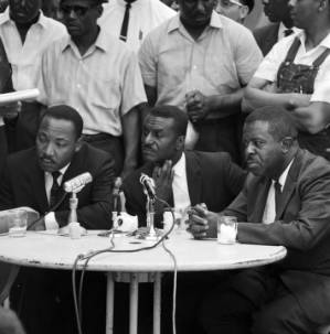 Martin Luther King Jr., Fred Shuttlesworth, and Ralph Abernathy holding a press conference at the Gaston Motel in Birmingham, Alabama.