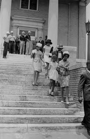 African American women walking down the steps of First Baptist Church in Gadsden, Alabama, after attempting to enter.