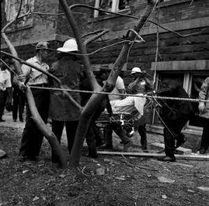 Men carrying one of the victims of the 16th Street Baptist Church bombing away from the building on a stretcher.