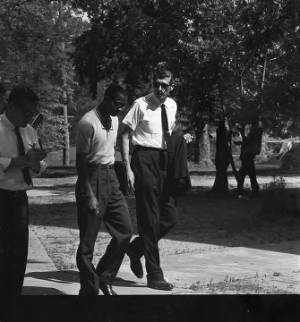 James Hood talking to a man while walking across campus at the University of Alabama.