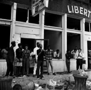 African Americans in front of the Silver Sands Restaurant and the Liberty Contracting Company across the street from 16th Street Baptist Church in Birmingham, Alabama.