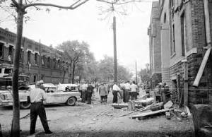 Damaged cars and debris in the street after the bombing of 16th Street Baptist Church in Birmingham, Alabama.
