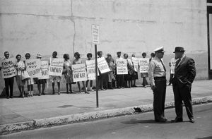 Civil rights demonstrators picketing outside businesses in downtown Birmingham, Alabama.