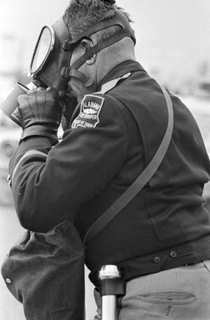 Alabama state trooper adjusting his gas mask on Bloody Sunday in Selma, Alabama.