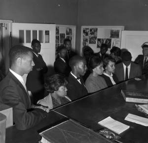 Officers booking civil rights demonstrators at the police department in Talladega, Alabama, after a sit-in at City Pharmacy.
