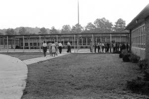 African American students entering Dixie Junior High School in Minor, Alabama, during the integration of the school.