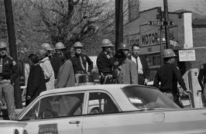 African Americans walking past the courthouse in Marion, Alabama, the day after the civil rights demonstration during which Jimmie Lee Jackson was shot.