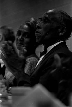 James and Willie Kolb applauding a speaker at the Jefferson Davis Hotel in Montgomery, Alabama, possibly during the semi-annual meeting of the Alabama Democratic Conference.
