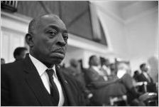 Man seated at Tabernacle Baptist Church in Selma, Alabama, probably listening to Martin Luther King, Jr., speak.