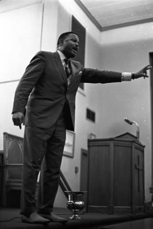 Hosea Williams speaking at a meeting at a church building.