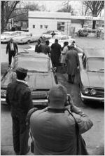 Men standing around a car in the parking lot outside Tabernacle Baptist Church in Selma, Alabama.