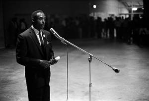 John Hulett speaking to an audience at the National Guard Armory on Dallas Avenue in Selma, Alabama, during a political rally featuring members of SNCC and the Dallas County Independent Free Voters Organization.