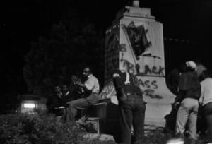 Students at the base of the Confederate monument in downtown Tuskegee, Alabama, during a nighttime demonstration protesting the acquittal of Marvin Segrest for the murder of Samuel L. Younge.