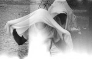 Two people running through the rain during a civil rights demonstration in Greensboro, Alabama.