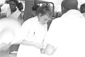 Woman from the Medical Committee for Human Rights, tending to an injured woman during a civil rights demonstration in Greensboro, Alabama.