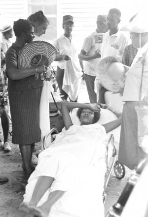 Woman lying on a stretcher during a civil rights demonstration in Greensboro, Alabama.