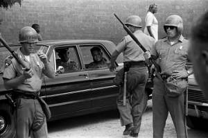 Mississippi Highway Patrol officers standing around a car in Philadelphia, Mississippi, probably during the "March Against Fear" begun by James Meredith.