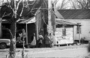 People standing outside a house near Harrison Street Baptist Church in Greenville, Alabama, before a meeting.