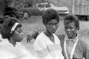 Three young women standing outside Harrison Street Baptist Church in Greenville, Alabama, during a student boycott of the Greenville Training School.