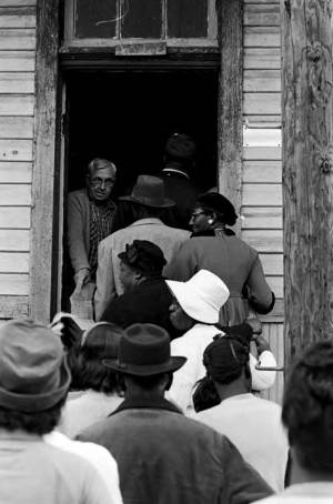 People entering and leaving a building in Lowndes County, Alabama, on election day.