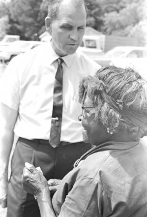 Man talking to a woman while standing in line on election day in Lowndes County, Alabama.