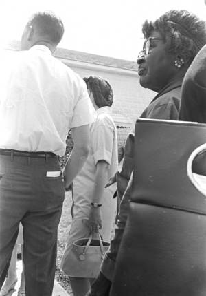People standing in line outside on election day in Lowndes County, Alabama.