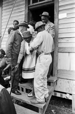 Elderly woman leaving a building in Lowndes County, Alabama, after voting on election day.
