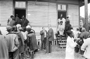 People entering and leaving a building in Lowndes County, Alabama, on election day.
