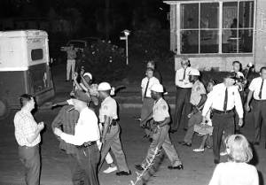 Police officers arresting several young men and women during a civil rights demonstration in Montgomery, Alabama.