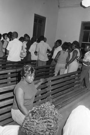 Audience leaving the auditorium of a church building, possibly after a civil rights meeting in Montgomery, Alabama.