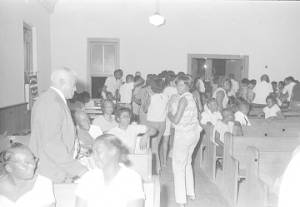 Audience leaving the auditorium of a church building, possibly after a civil rights meeting in Montgomery, Alabama.
