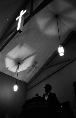 Richard Boone addressing an audience in a church building in Montgomery, Alabama.