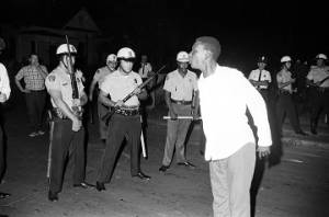Man shouting at a line of police officers who had blocked their march to the Governor's Mansion in Montgomery, Alabama.