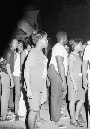 Group standing on a sidewalk in a neighborhood in Montgomery, Alabama, during a civil rights demonstration.