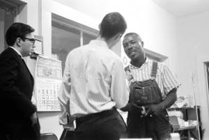 Roosevelt Barnett speaking to two men in an office, possibly the headquarters of the SCLC in Montgomery, Alabama.