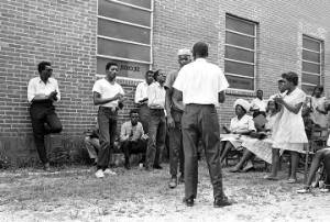 Dan Houser and another man, standing in front of an audience outside the First Missionary Baptist Church in Prattville, Alabama, during a meeting of the Autauga County Improvement Association.