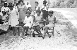 Audience seated in chairs outside the First Missionary Baptist Church in Prattville, Alabama, during a meeting of the Autauga County Improvement Association.