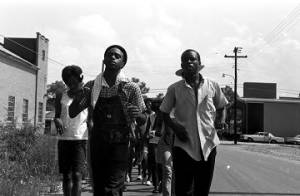 Edward Rudolph leading marchers down a street in Prattville, Alabama, during a demonstration sponsored by the Autauga County Improvement Association.