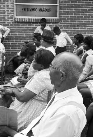 Audience seated in chairs outside the First Missionary Baptist Church in Prattville, Alabama, during a meeting of the Autauga County Improvement Association.