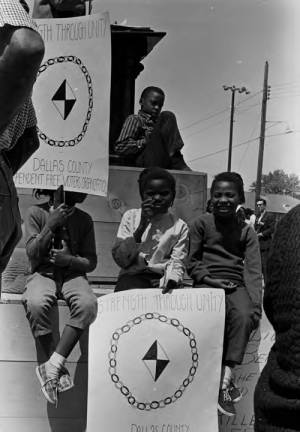 Children holding posters of the Dallas County Independent Free Voters Organization during a commemoration of the Selma to Montgomery March at George Washington Carver Park in Selma, Alabama.