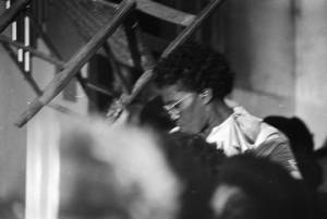 Pearl Moorer holding up a chair while standing in the audience at Brown Chapel AME Church in Selma, Alabama.