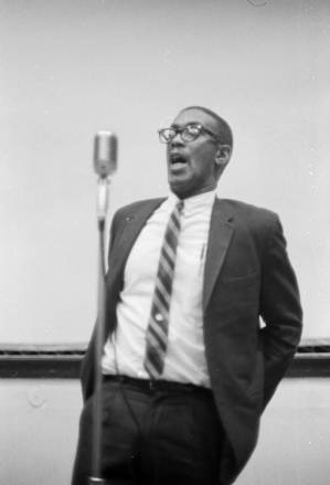 Dr. Burcham Phillips speaking during a meeting in the Tuskegee Institute gymnasium, which was held to discuss student demonstrations protesting the murder of Samuel L. Younge.
