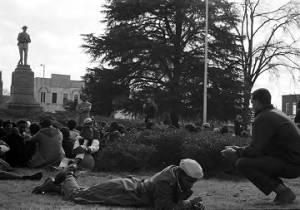 Dr. Frank Toland addressing a crowd seated in front of the Confederate monument in Tuskegee, Alabama, during a student demonstration to protest the murder of Samuel L. Younge, a civil rights worker.